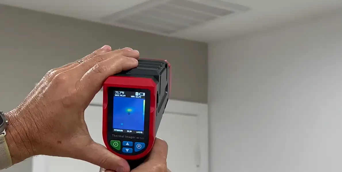Leak detection technician using acoustic equipment to trace a hidden water leak in Fort Collins